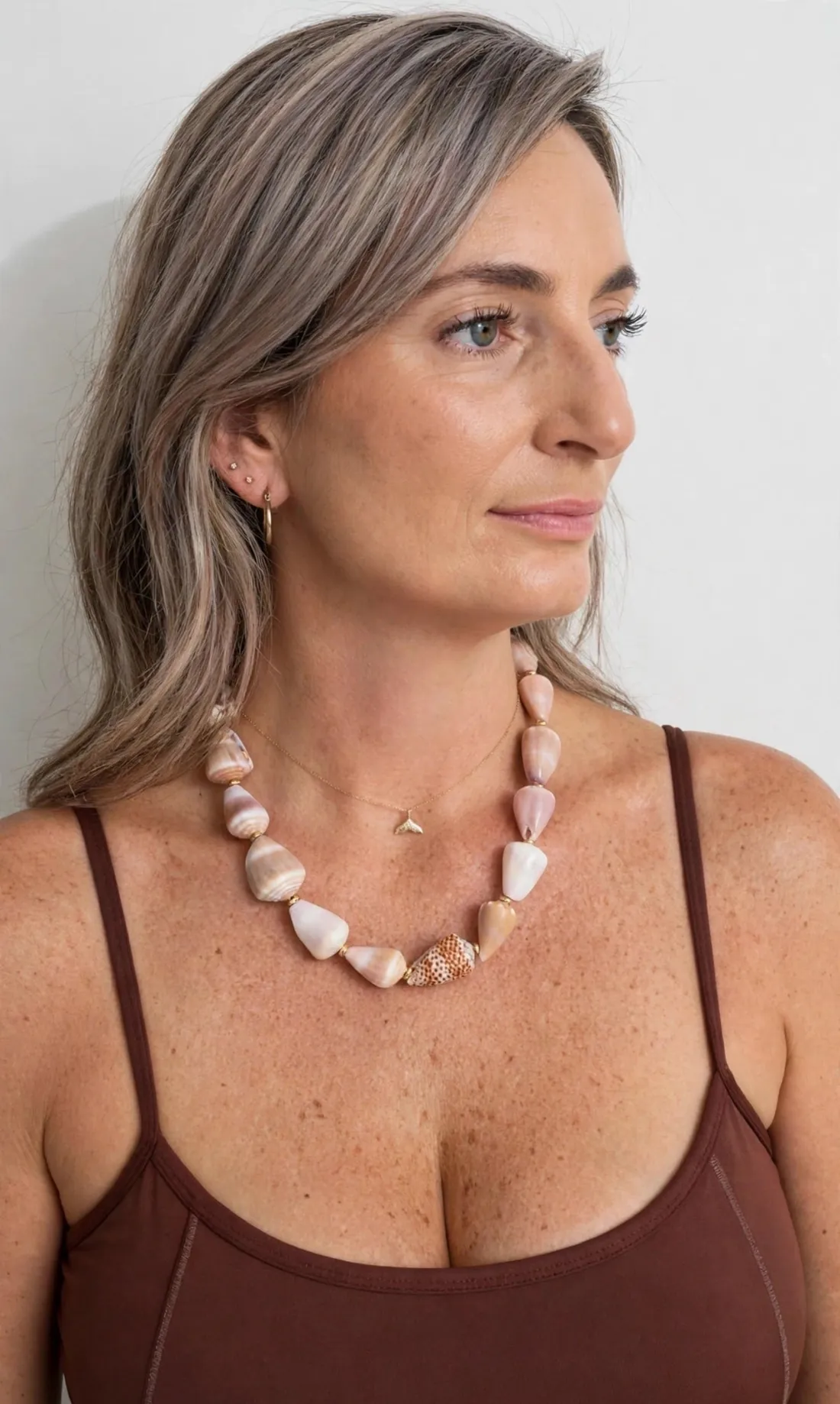 Woman wearing the Hawaiian Shell Lei Necklace, strung from cone shells hand-picked on Maui