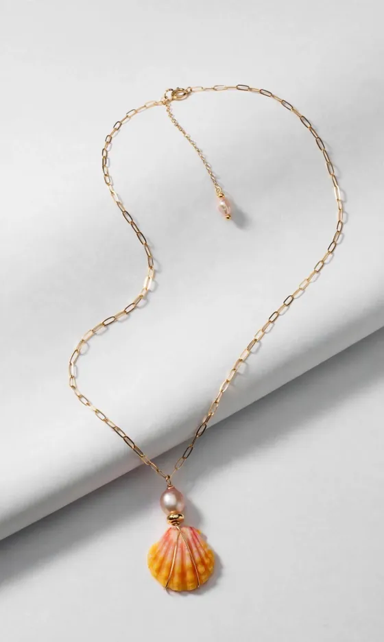 Sunrise scallop shell and pink pearl pendant on a gold paperclip chain